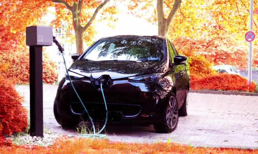 An electric car charging among trees
