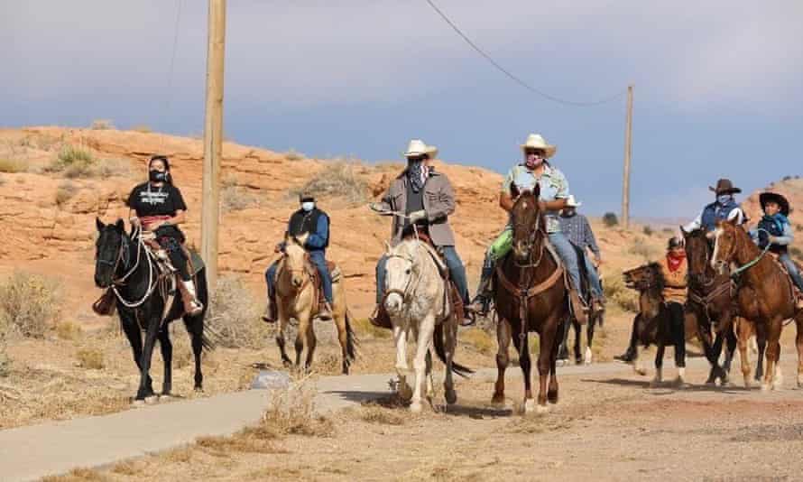 Allie Young, left, with a group of Native Americans, riding on horseback to the polls in 2020.