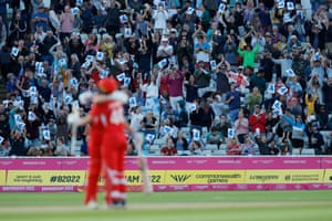 Fans celebrate in the stands as England’s Amy Jones and Nat Sciver embrace after Jones scored a four to give England victory in their group game against New Zealand.