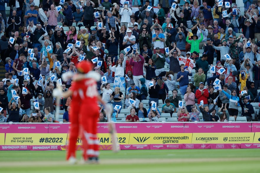 Fans celebrate in the stands as England's Amy Jones and Nat Sciver hug each other after Jones scored a four to give England the win.