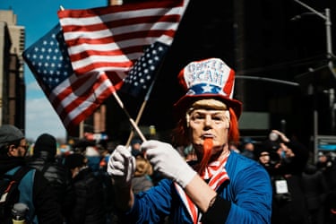 New York CityA demonstrator waves two US flags.