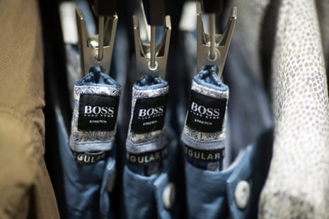 Hugo Boss logos sit inside the waistbands of mens trousers inside Hugo Boss AG’s store on Regent Street in London