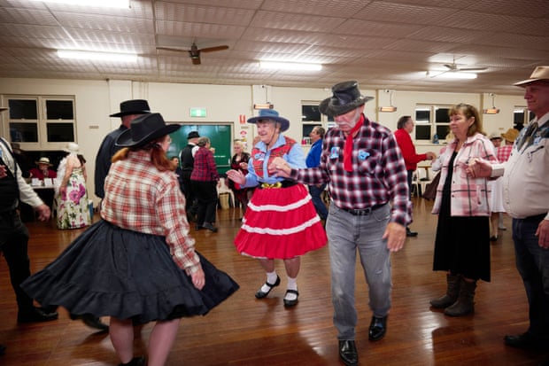Carol Parsons (in red striped skirt) and John Parsons (black hat) at the club's western party.