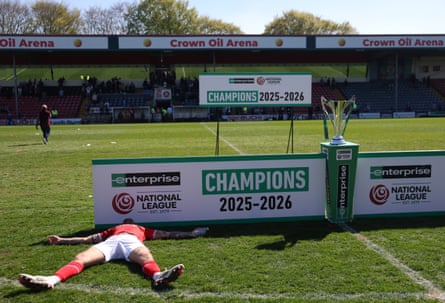 Zak Johnson of York on the ground next to the National League trophy
