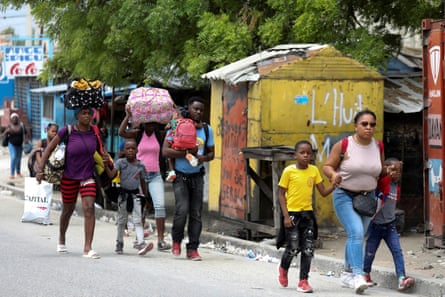 Residents flee their homes after gun-battles between rival gangs in Port-au-Prince.