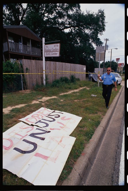 police set up police tape while sign on the ground says 'disobey unjust laws'