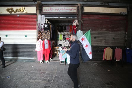 A man holds walks through the al-Hamidiyeh market in old Damascus, Syria, on Monday.