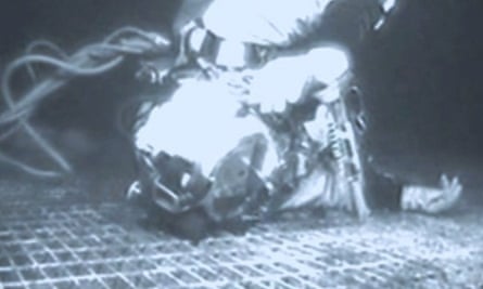 A black-and-white photo of Lemons lying unconscious at the bottom of the North Sea, wearing a diving suit and helmet.