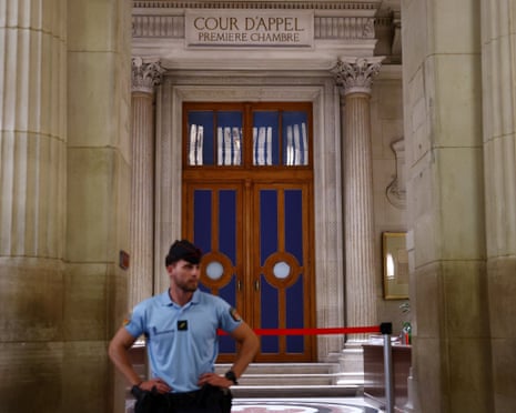 A French gendarme stands in front of the first Chamber of the Paris Court of Appeal before the start of the hearing for the verdict in the appeal trial of French far-right leader Marine Le Pen.