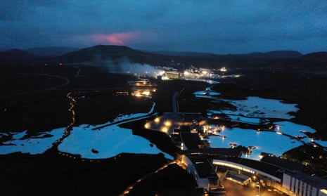March 2021: A red shimmer from magma from the erupting Fagradalsfjall volcano is visible behind the famous Blue Lagoon, near the town of Grindavik.