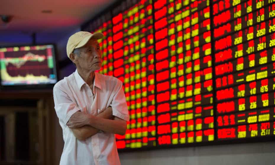 An investor watches the stock market plunge in Shanghai. 