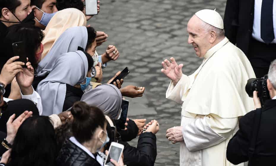 Pope Francis blesses nuns as he leaves after holding a limited public audience at the San Damaso courtyard in the Vatican on 30 September. 