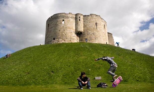 Skateboarders at the base of the mound of Clifford's Tower, York