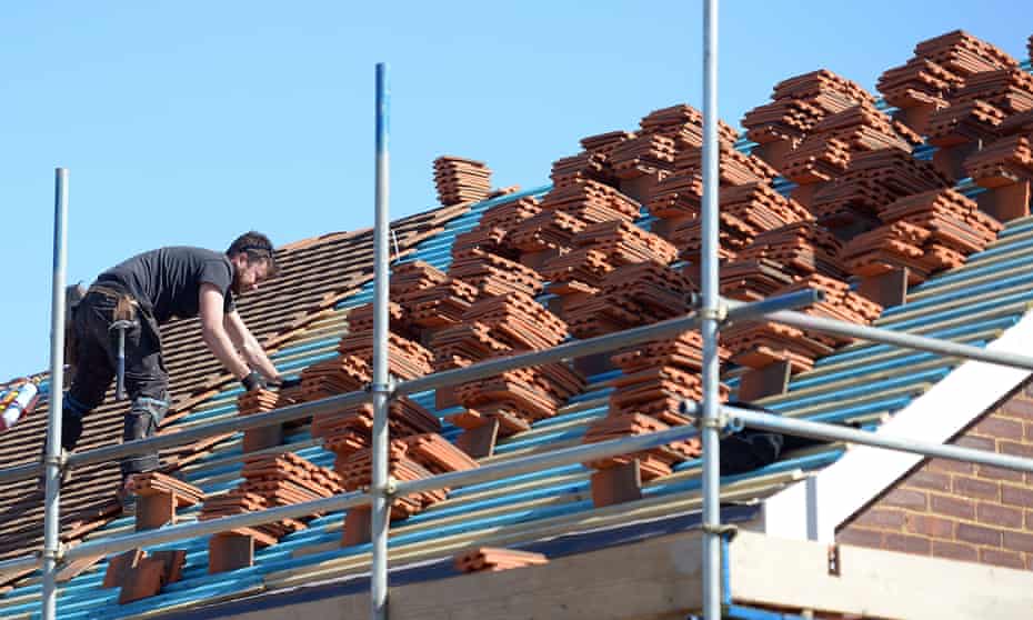 a roofer fits roof tiles