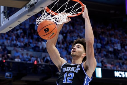 The Duke forward, Cameron Boozer, dunks during an NCAA college game against North Carolina.