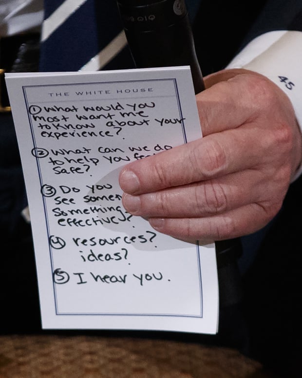 President Donald Trump holding his notes