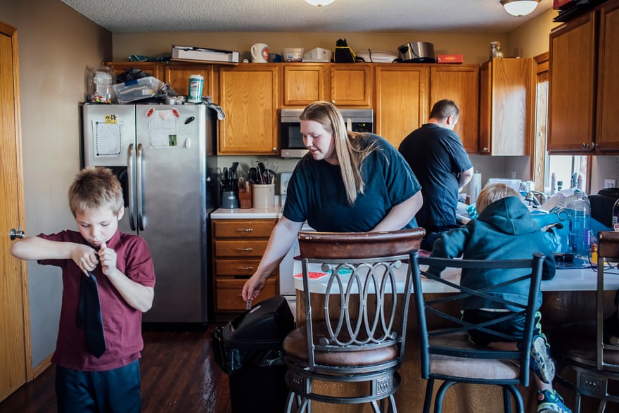 Jessica Rebeschini, 26, with her sons Karter, 4, Chase, 7, and her husband Ron, 34 in their home in Boundurant, IA on December 22, 2019.