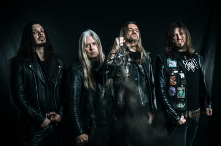 German band Sodom standing in a dark room.