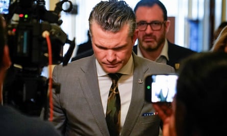 man in suit and tie with head bowed
