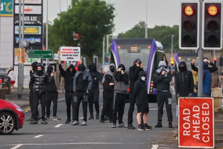 A crowd of protesters gathering in a road in Belfast the day after the stabbing.