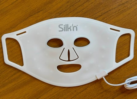Silk’n light therapy mask laid flat on a table.