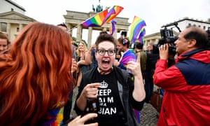 People celebrate the legalisation of same-sex marriage in front of the Brandenburg Gate in Berlin.