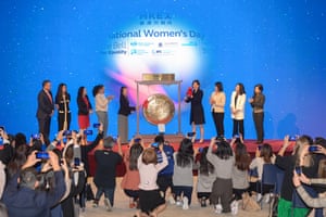 Attendants ring the gong during a ceremony held by the Hong Kong Exchanges and Clearing Limited (HKEX) to mark International Women’s Day at the HKEX Connect Hall