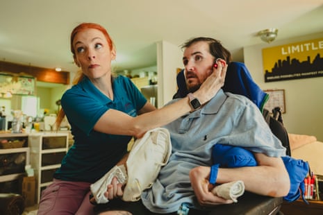 A therapist turning on a headlaser set on a patient