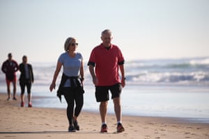 The PM and his wife Lucy walk along Twin Waters beach on the Sunshine Coast in Queensland.