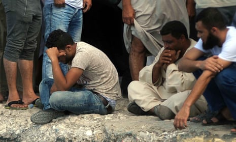 Relatives of people missing after the shipwreck await news on the quayside in Rosetta, Egypt