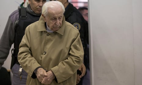 Omar Graffigna, who was head of Argentina’s air force during the military dictatorship, is escorted to his trial in Buenos Aires.