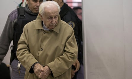 Omar Graffigna, who was head of the Air Force during Argentina’s military dictatorship, is escorted by police to his trial in Buenos Aires in May.