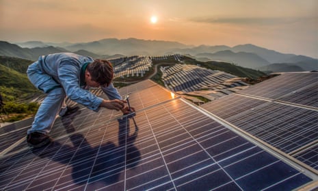 A worker at Xinyi photovoltaic power station in Songxi, China. China will lead the world for growth in renewable power, the IEA has predicted.
