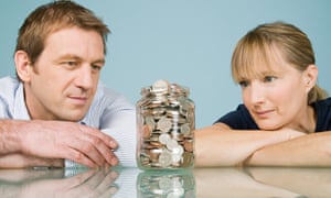 Couple looking at jar of coins
