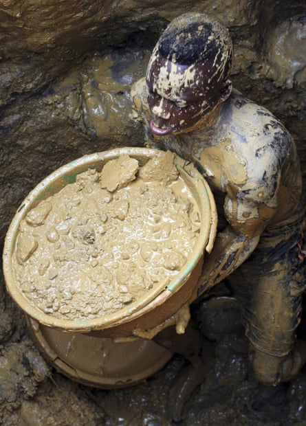 Miner with bucket of mud at a gold mine in DRC