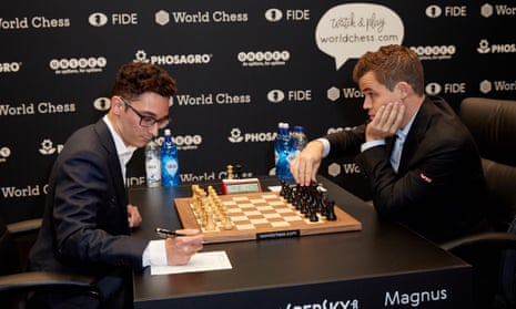 Magnus Carlsen and Fabiano Caruana at the start of the first of 12 world championship games. It ended in a draw after seven hours.