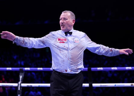 Referee Howard Foster with his shirt splattered with blood during the WBO heavyweight title bout between Fabio Wardley and Daniel Dubois