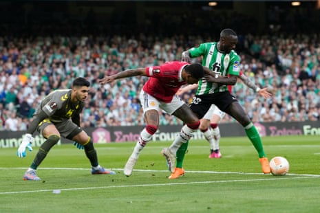 Youssouf Sabaly clears the danger under pressure from Marcus Rashford.
