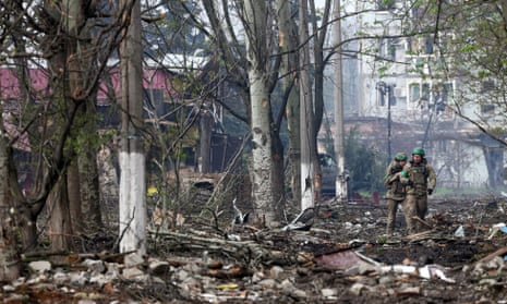 Ukrainian servicemen walk down a street in Bakhmut.