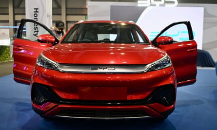 Front view of a futuristic looking red SUV with the doors open