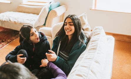 Two sisters on a sofa with their mum