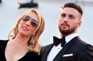 A man in a tuxedo and a woman in a black evening gown