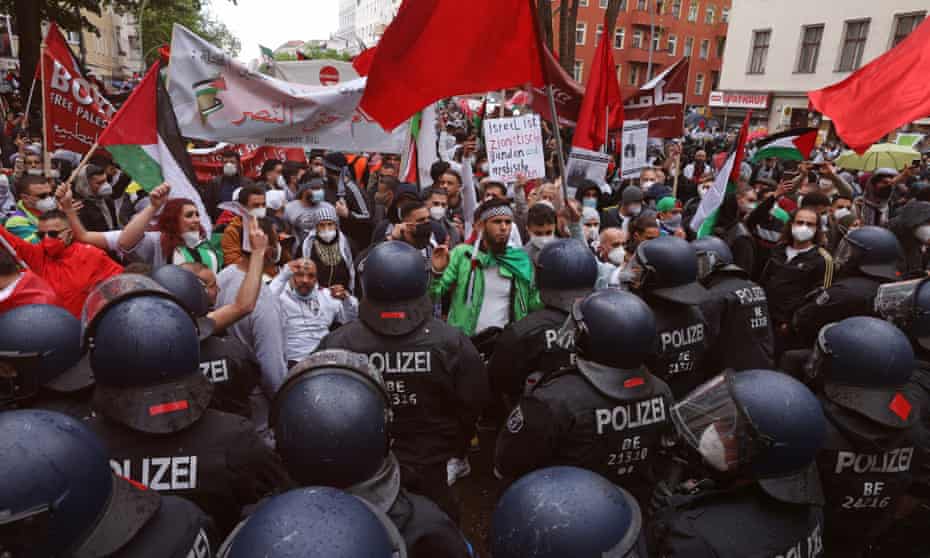Riot police face protesters in the Neukölln district in Berlin