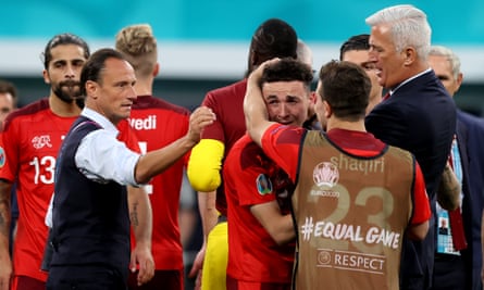 A distraught Ruben Vargas is consoled by his Switzerland teammates after he blasted his penalty over the bar.