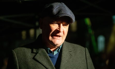 Mick Lynch outdoors in a coat and flat cap