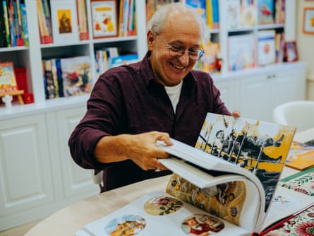 Ivan Malkovych, founder of A-BA-BA-HA-LA-MA-HA publishing house, shows its books.