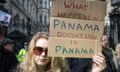 A woman holds up a sign at a protest against those identified in documents leaked by an anonymous source at Mossack Fonseca