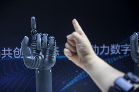 An attendee controls an AI-powered prosthetic hand during 2021 World Artificial Intelligence conference in Shanghai.