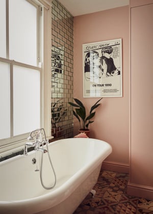 The en-suite bathroom with floor-to-ceiling mirror tiles and a vintage Sonic Youth poster.