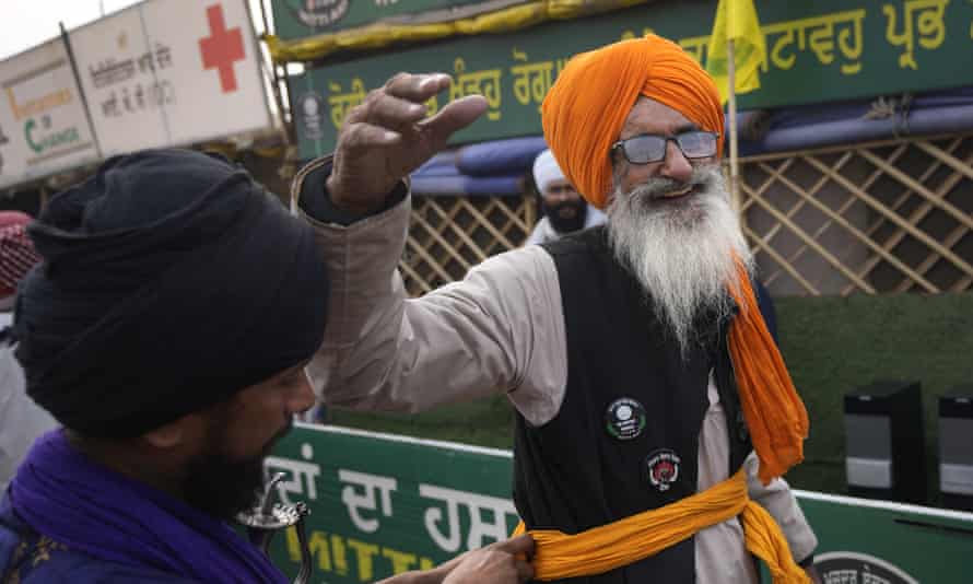 An elderly farmer in Singhu reacts to the news of the repeal of farm laws.